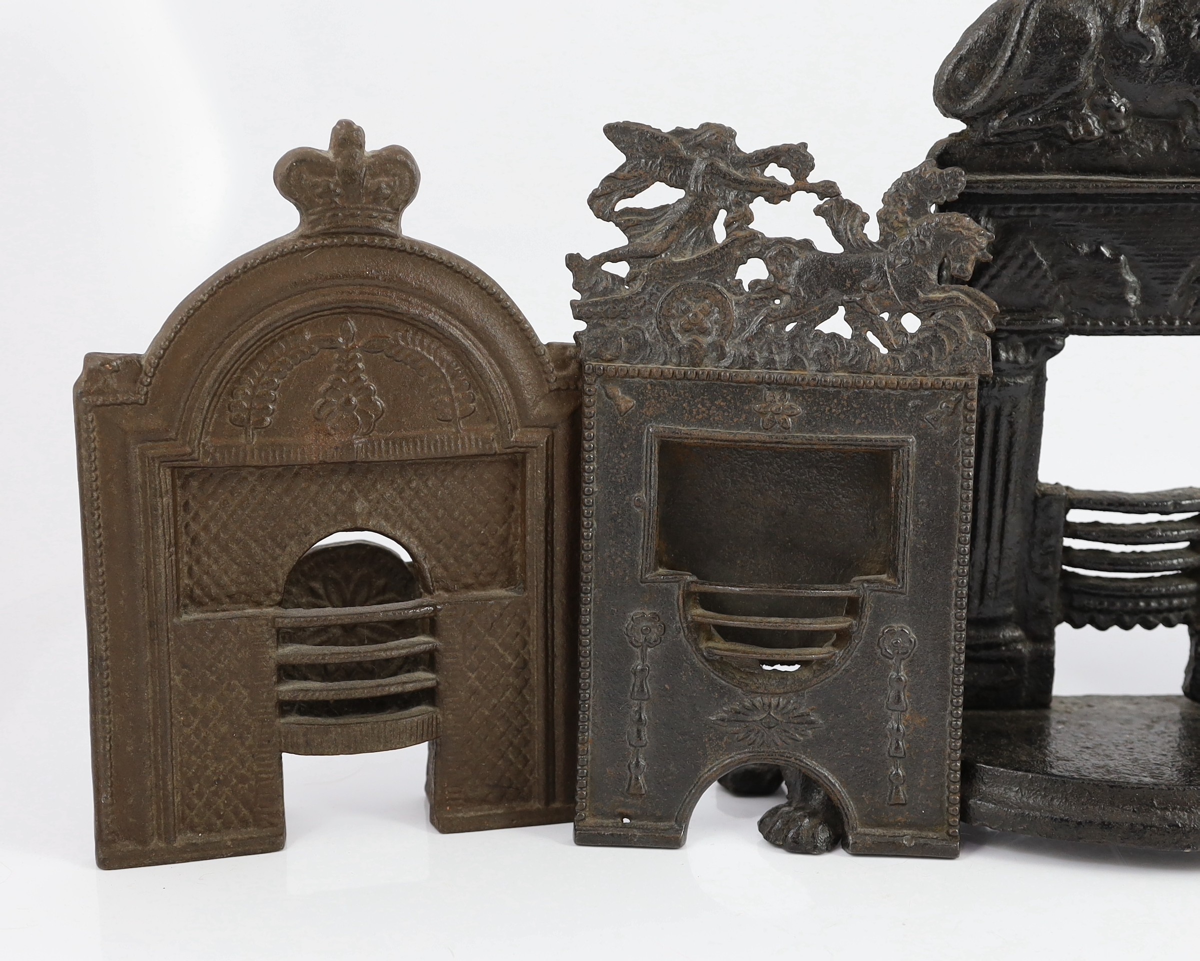 Four 19th century cast iron fire grate models, largest 12in. high